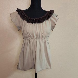 Tan blouse with brown trim. short sleeved.
